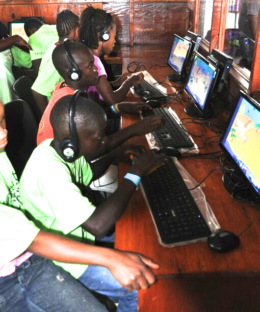 Children learning computer skills in a computer lab